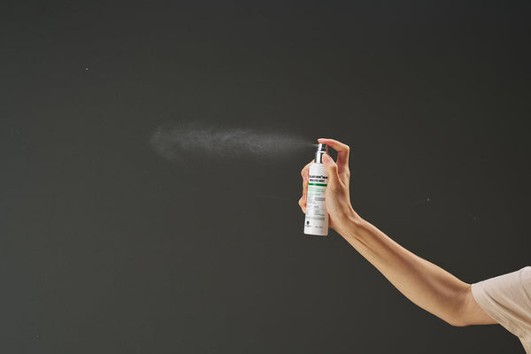 Tov Beauty Trandmi Collabenon+ NMN Healing Mist 100ml in a clear bottle with a spray nozzle and floral background.