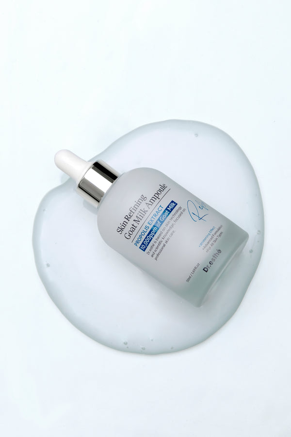 Dr. Esthe Skin Refining Goat Milk Ampoule 50 ml in a dropper bottle showcasing its creamy texture for facial care.