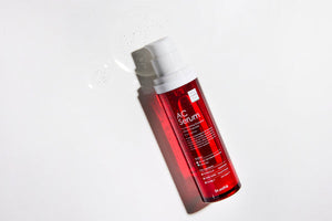 Dr. Esthe AC Serum 50ml in a clear bottle with a dropper, showcasing a lightweight serum texture and elegant packaging.