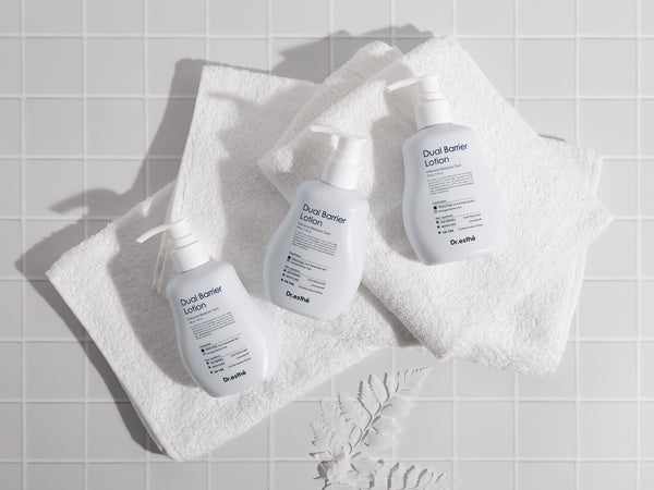 Dr. Esthe Dual Barrier Lotion 200ml bottle with a sleek design, showcasing its moisturizing formula for skin care.