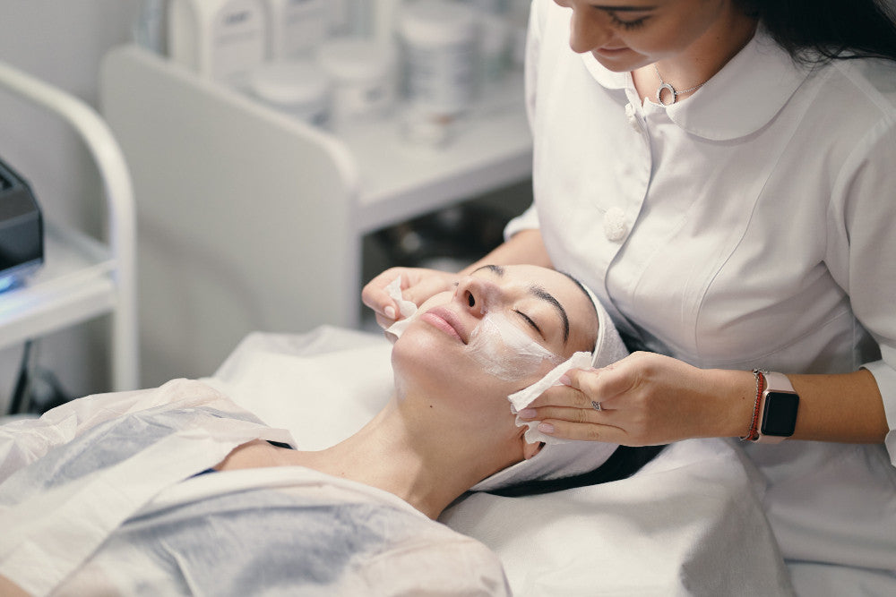 Customized facial voucher for acne treatment at The Aesthetics Spa, featuring a serene spa setting and skincare products.