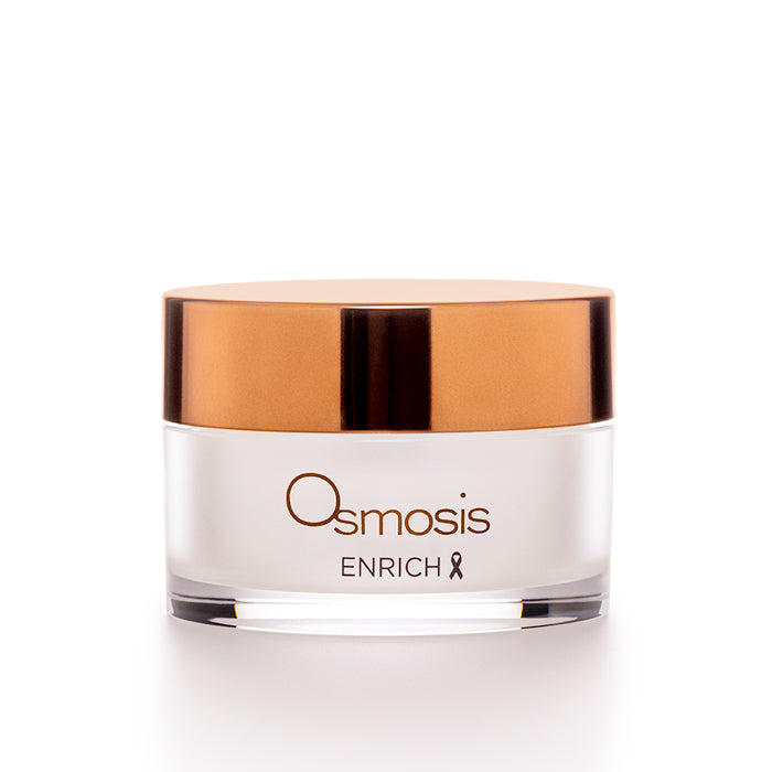 Osmosis Beauty Enrich Restorative Face and Neck Cream jar on a wooden surface with soft lighting.