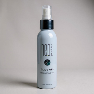 NeoGenesis Glide Gel in a clear tube, showcasing its smooth texture and gel consistency for skincare applications.