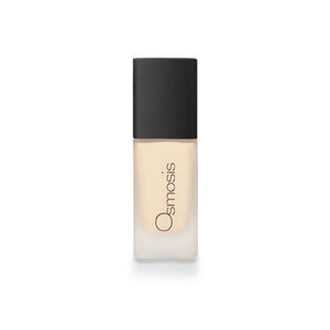 Osmosis Flawless Foundation in Ivory, showcasing smooth texture and creamy consistency in a sleek bottle.