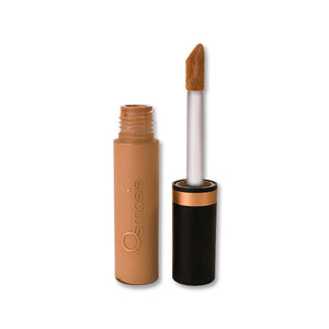 Osmosis Beauty Flawless Concealer in Sienna, showcasing the sleek applicator and creamy texture in a close-up view.