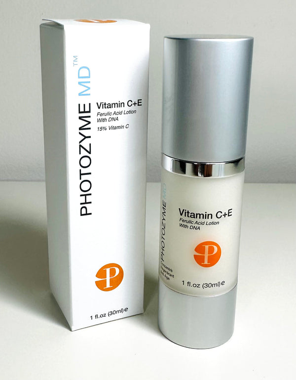 Photozyme Vitamin C+E + Ferulic Acid Lotion in a clear bottle, showcasing a lightweight facial serum texture.
