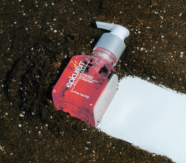 Epicuren Discovery Herbal Cleanser in a serene setting, showcasing the bottle with lush greenery in the background.