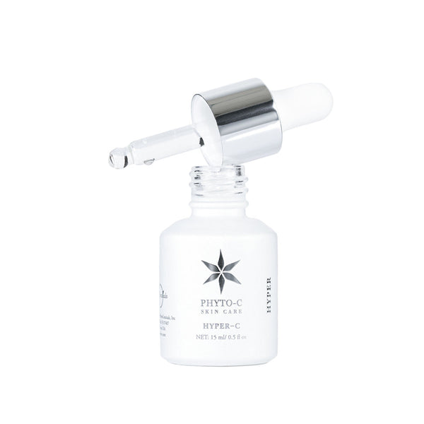 Phyto-C Skin Care HYPER-C serum in a 15 ml bottle with a dropper, showcasing its smooth texture and vibrant packaging.