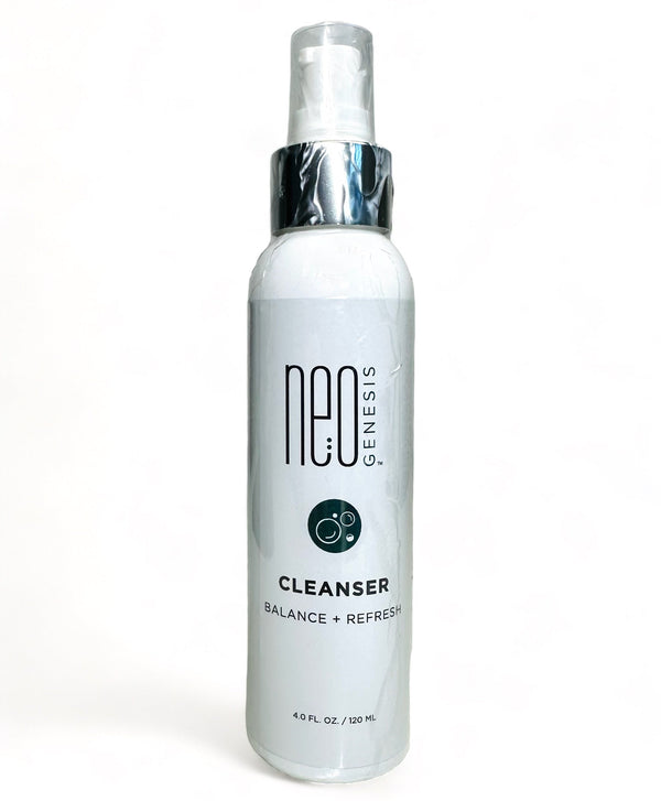 NeoGenesis Cleanser in a sleek bottle with a pump, surrounded by fresh greenery, highlighting its gentle formula.