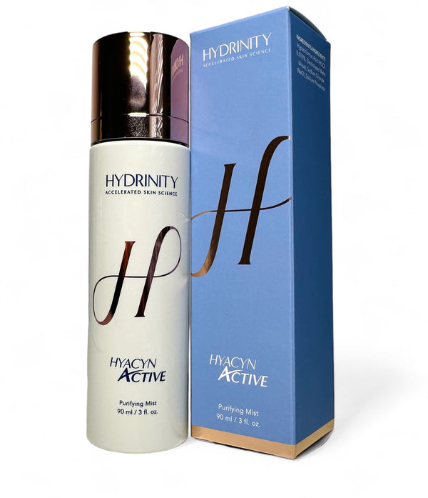 Hydrinity Hyacyn Active cleanser in a sleek bottle with a pump, placed on a soft towel with a blurred background.