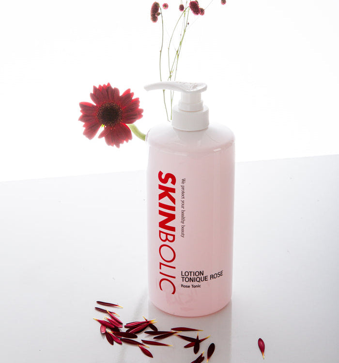 Skinbolic Lotion Tonique Rose cream in a sleek bottle with a pink label, showcasing its floral essence.
