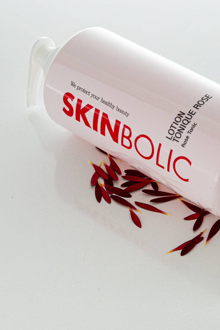 Skinbolic Lotion Tonique Rose cream in a sleek bottle with a pink label, showcasing its floral essence.