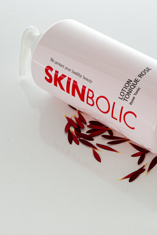Skinbolic Lotion Tonique Rose cream in a bottle with a pink label, featuring floral design and a pump dispenser.