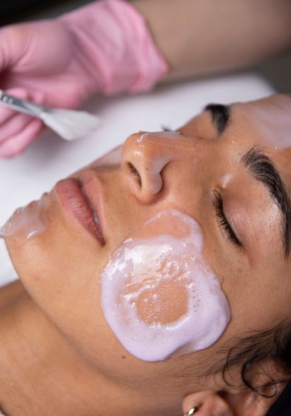 Customized facial voucher from The Aesthetics Spa featuring a serene spa setting with medical-grade facial equipment.