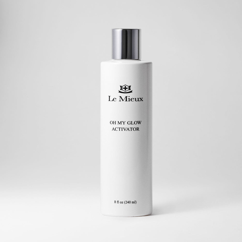 Le Mieux Oh My Glow Activator toner in an 8oz bottle with clear liquid and a white cap, displayed against a plain background.