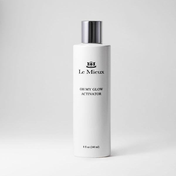 Le Mieux Oh My Glow Activator toner in an 8oz bottle with clear liquid and a white cap, displayed against a plain background.