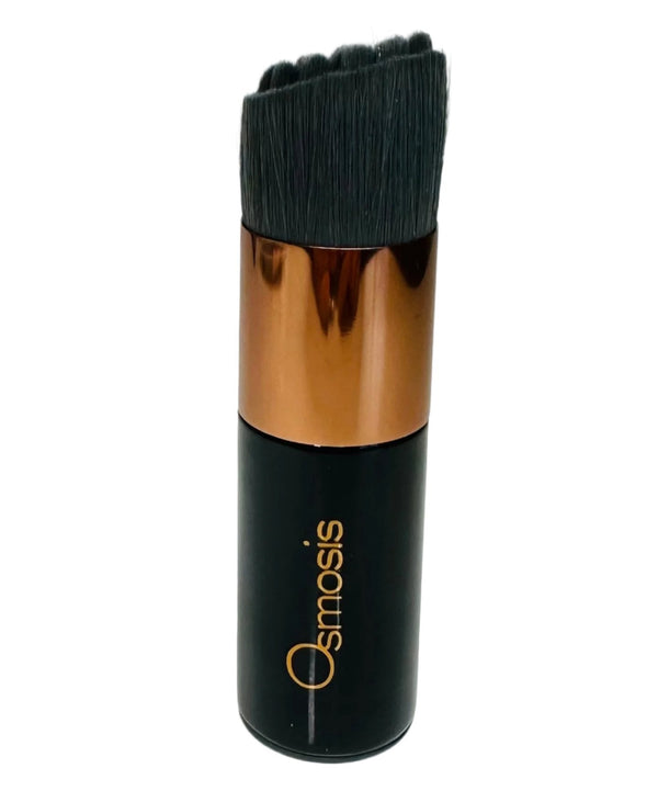Osmosis Beauty Cleansing Kabuki Brush with soft bristles, perfect for applying skincare products evenly on the skin.