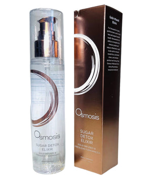 Osmosis Beauty Sugar Detox Elixir bottle with a clear liquid, surrounded by fresh fruits and herbs on a wooden surface.