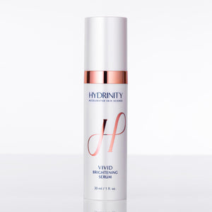 Hydrinity Vivid Brightening Serum in a sleek bottle with a dropper, surrounded by fresh, vibrant ingredients.