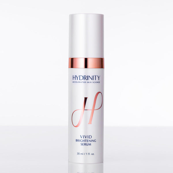 Hydrinity Vivid Brightening Serum in a sleek bottle with a dropper, surrounded by fresh, vibrant ingredients.