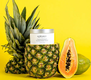 Epicuren Discovery Papaya Pineapple Bamboo Body Polish in a 6.7 Fl Oz jar surrounded by tropical fruits and bamboo.