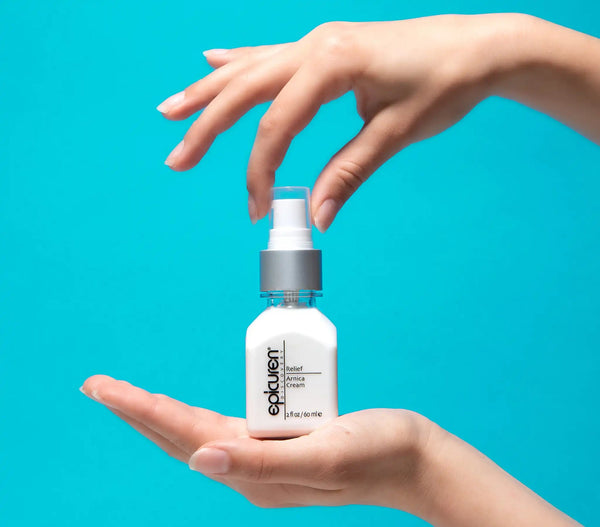 Epicuren Discovery Muscle Relief Arnica Cream in a jar, surrounded by natural elements, showcasing its soothing texture.