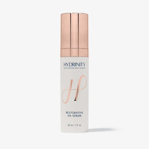 Hydrinity Restorative HA Serum in a glass bottle, featuring dropper applicator and clear liquid formula for hydrating skin.