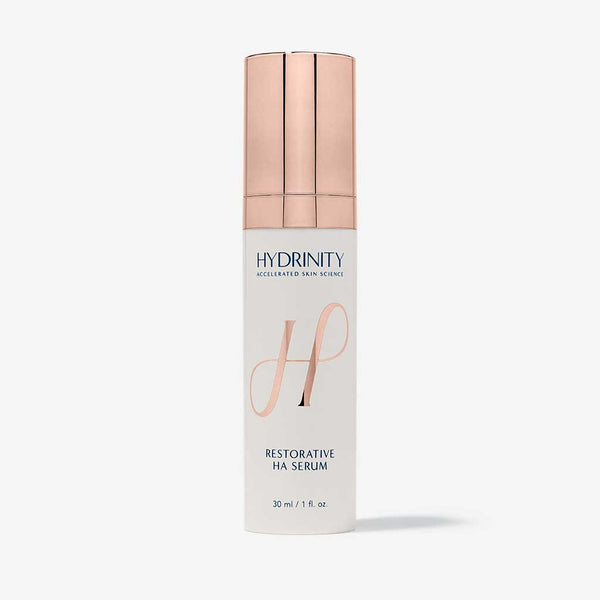 Hydrinity Restorative HA Serum in a glass bottle, featuring dropper applicator and clear liquid formula for hydrating skin.