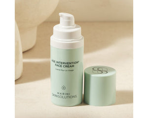 Jan Marini Age Intervention Face Cream in a jar surrounded by a soft towel and spa-like setting.