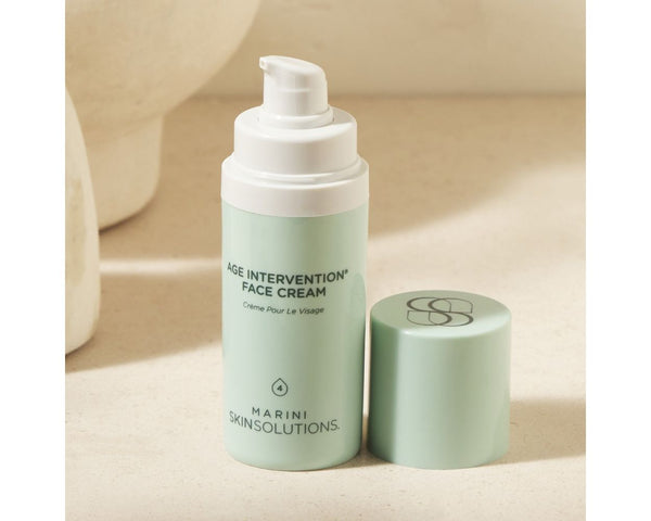 Jan Marini Age Intervention Face Cream in a jar surrounded by a soft towel and spa-like setting.