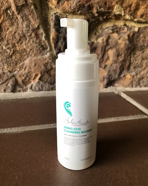 Bel Mondo Amino Acid Cleansing Mousse in a 5.07 oz bottle, featuring a rich, foamy texture for gentle cleansing.