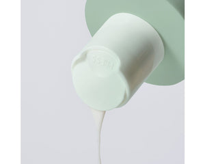 Jan Marini Bioglycolic Face Cleanser in a bathroom setting, showcasing the bottle and its sleek design.