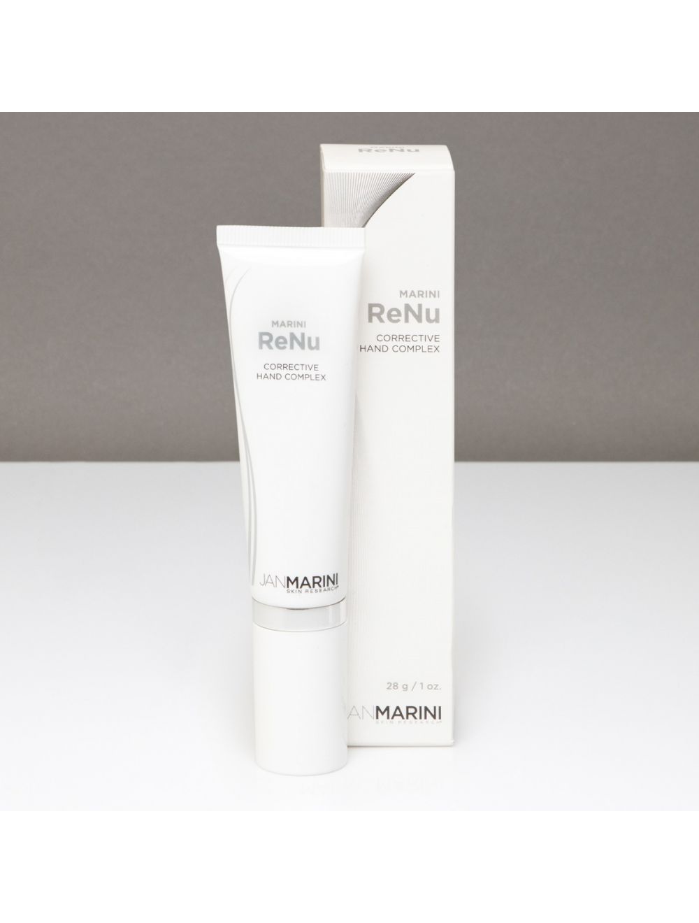 Jan Marini ReNu Corrective Hand Complex for dark spots in a sleek tube, showcasing its elegant packaging and label design.
