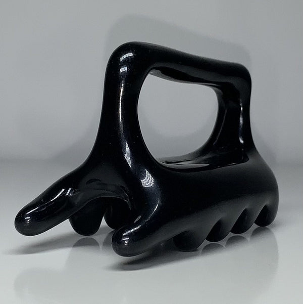 Black Halylo fascia facial and body massage tool with G-types design for effective chin and body massage.