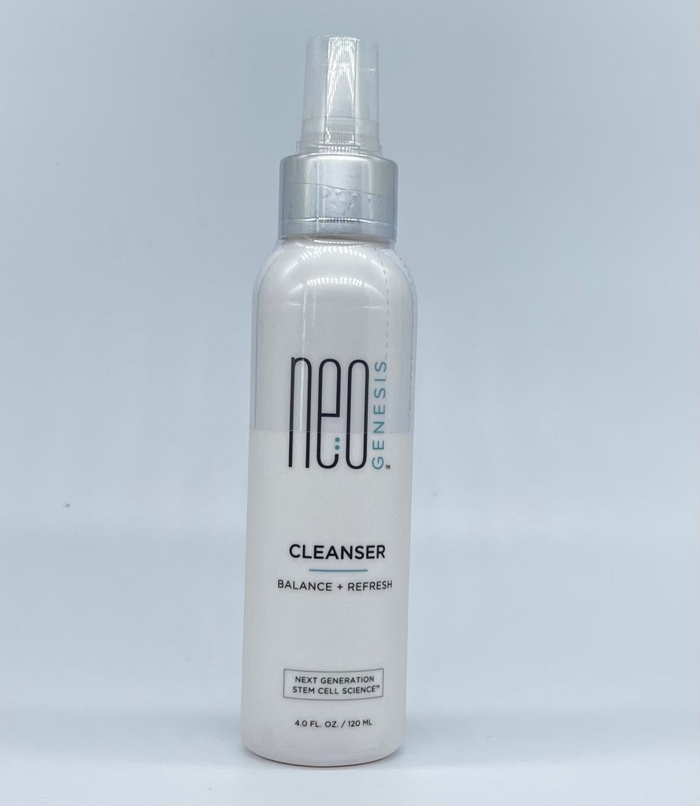 NeoGenesis Cleanser in a sleek bottle with a pump, surrounded by fresh greenery, highlighting its gentle formula.