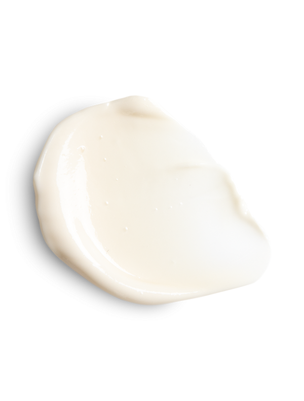 Jan Marini Marini Luminate Face Lotion in a creamy texture smear on a clean surface, showcasing its moisturizing properties.