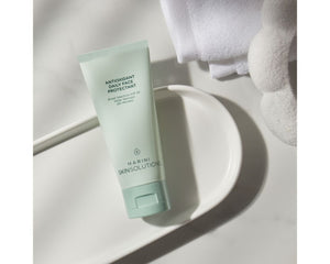 Jan Marini Antioxidant Daily Face Protectant SPF 33 in a bathroom setting, highlighting dark spot protection features.