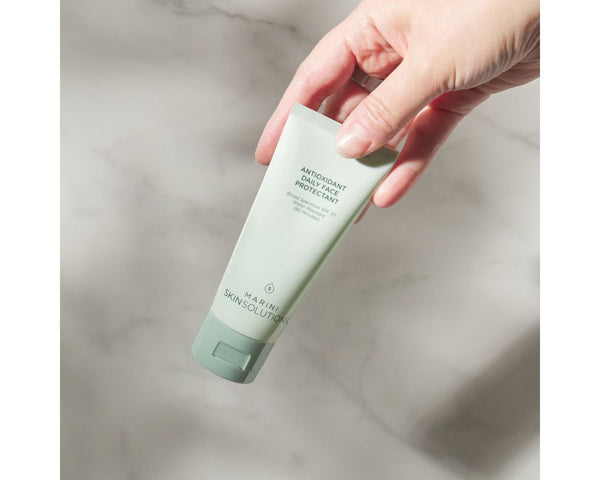 Jan Marini Antioxidant Daily Face Protectant SPF 33 in a bathroom setting, designed to reduce dark spots and protect skin.