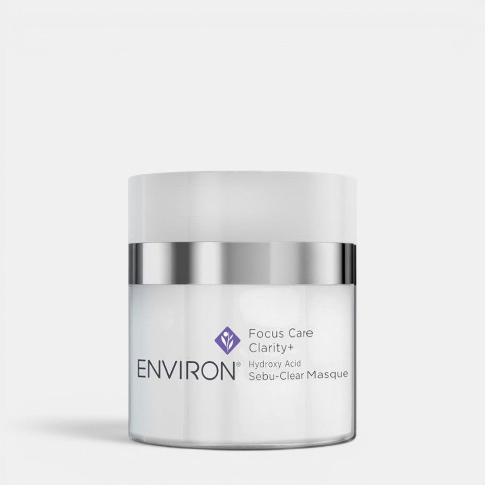 Environ Sebu-Clear Masque in a jar, a skincare mask and exfoliator for acne-prone skin, with a white and green packaging design.