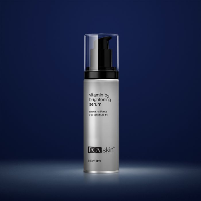 PCA Skin Vitamin B3 Eye Brightening Serum in a dropper bottle, designed for eyes, neck, and lips, on a soft surface.